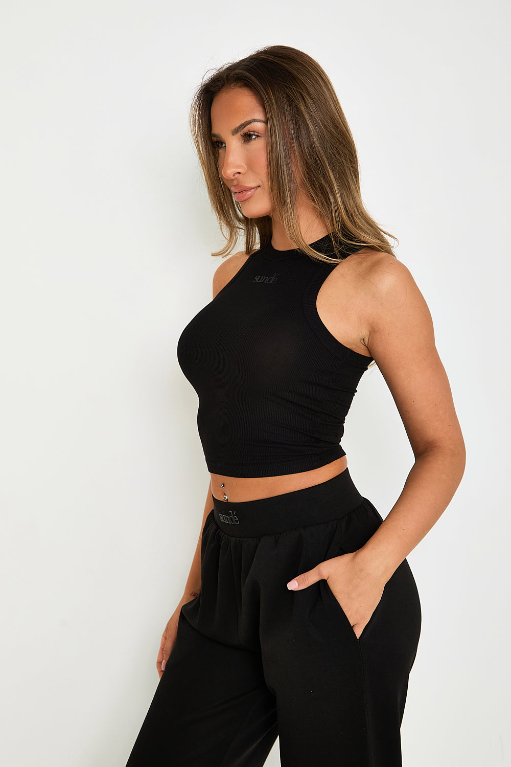 Elevate your essentials with our Ribbed Racer Tank, crafted from a premium blend of modal and elastane. This luxuriously soft, lightweight, and stretchy tank features a sophisticated ribbed texture and a chic racerback design that allows for a full range of motion, making it perfect for layering or wearing alone. The tank also includes subtle tonal rubber Sundé branding for an added touch of elegance. Ideal for those who appreciate quality and practicality, the Ribbed Racer Tank seamlessly adapts to any occ