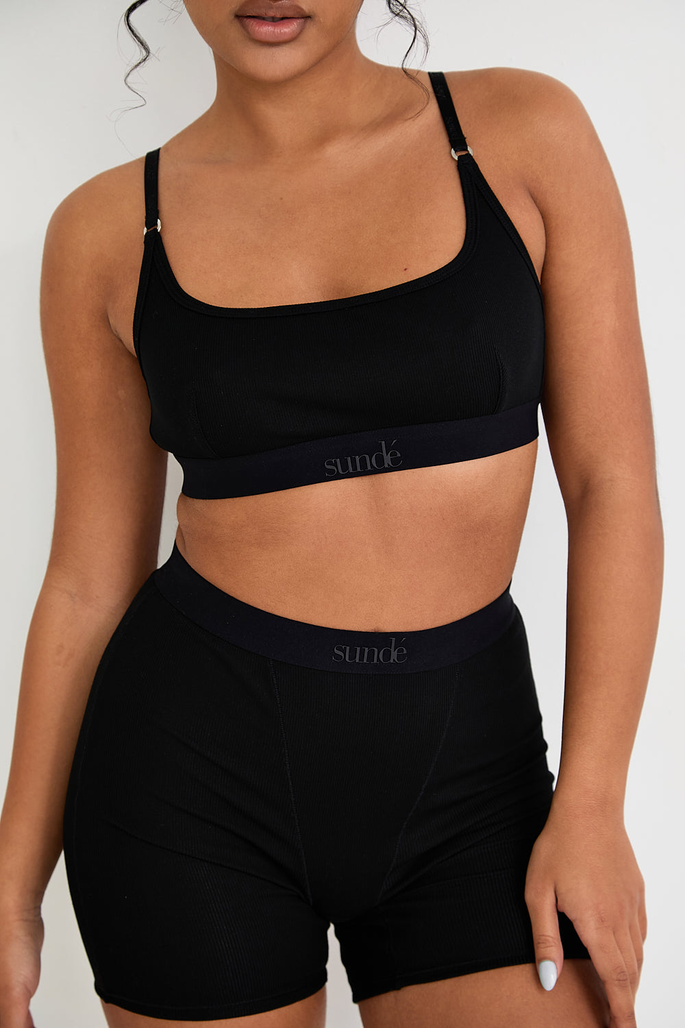 Our Ribbed Boxer in Black is the ideal choice for those seeking more coverage. With its high-rise waist and comfortable, full-coverage design, this boxer is sure to become a staple in your collection. The ribbed fabric provides a tailored fit while the elastic waistband, adorned with our signature logo, ensures a secure, all-day hold. Whether you're relaxing at home or getting ready for bed, these boxers offer unmatched comfort.