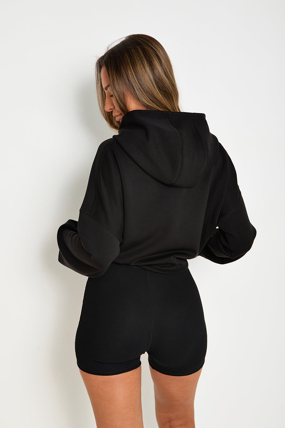 this Black Boxy Cropped Hoodie is the perfect addition to any loungewear collection. Its soft and comfortable fabric makes it ideal for lazy Sundays, while its matching modal blend flare joggers and ribbed boxer pants create a stylish, yet relaxed look.