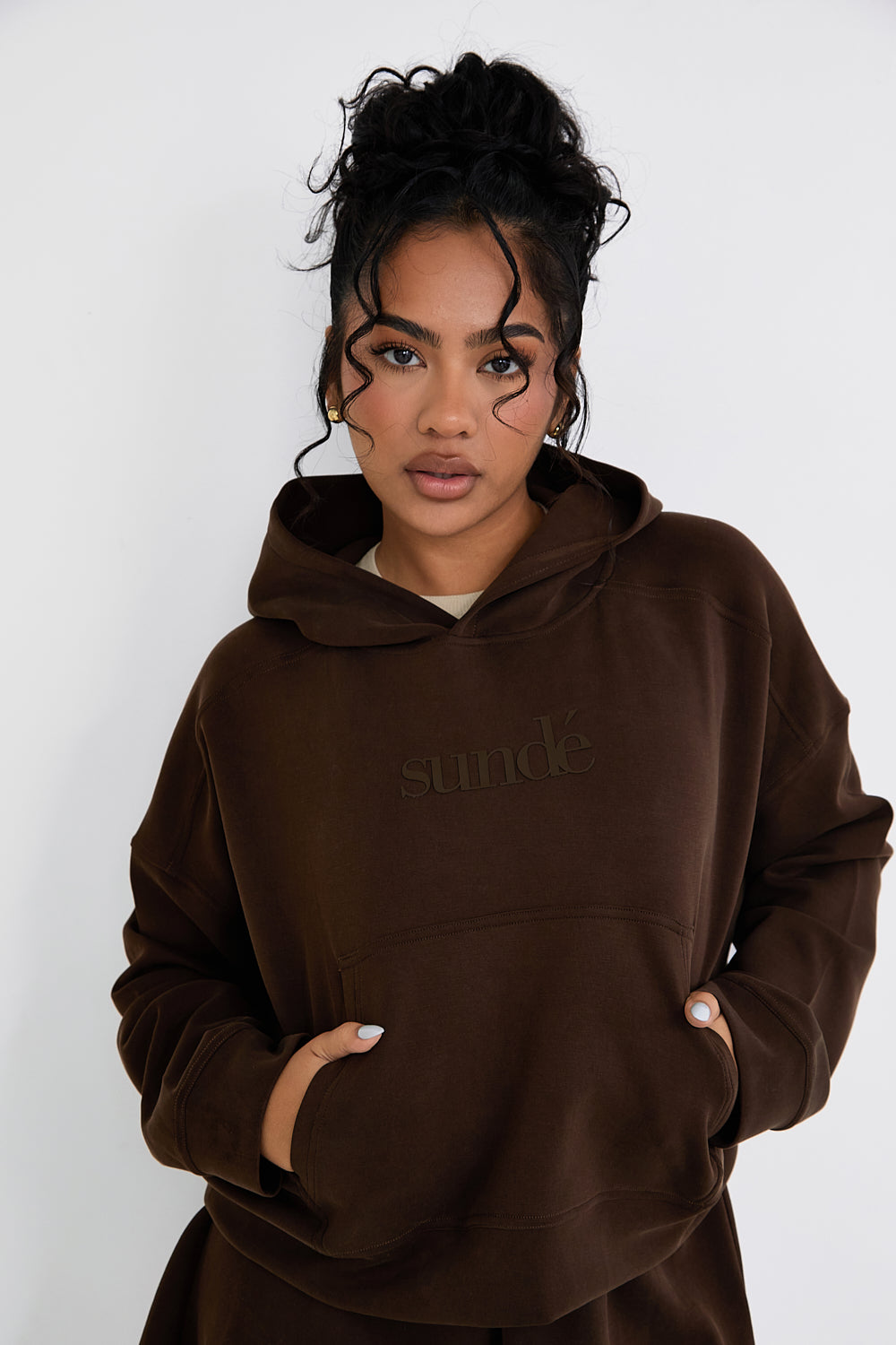 Stay cozy and stylish with our Boxy Cropped Hoodie in rich Chocolate. Made from soft modal, it's perfect for lazy days, paired with matching lounge shorts. Our signature tonal rubber print adds a subtle and sophisticated touch. Upgrade your loungewear collection today.