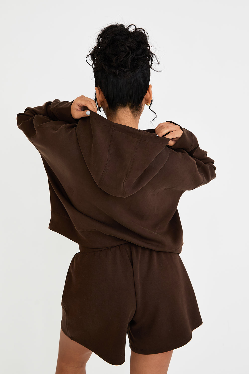 Stay cozy and stylish with our Boxy Cropped Hoodie in rich Chocolate. Made from soft modal, it's perfect for lazy days, paired with matching lounge shorts. Our signature tonal rubber print adds a subtle and sophisticated touch. Upgrade your loungewear collection today.