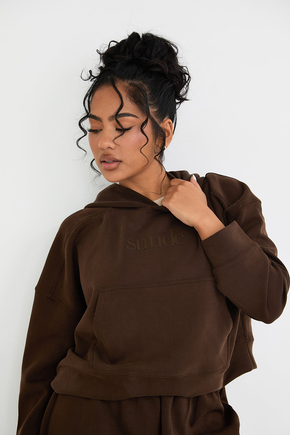 Stay cozy and stylish with our Boxy Cropped Hoodie in rich Chocolate. Made from soft modal, it's perfect for lazy days, paired with matching lounge shorts. Our signature tonal rubber print adds a subtle and sophisticated touch. Upgrade your loungewear collection today.