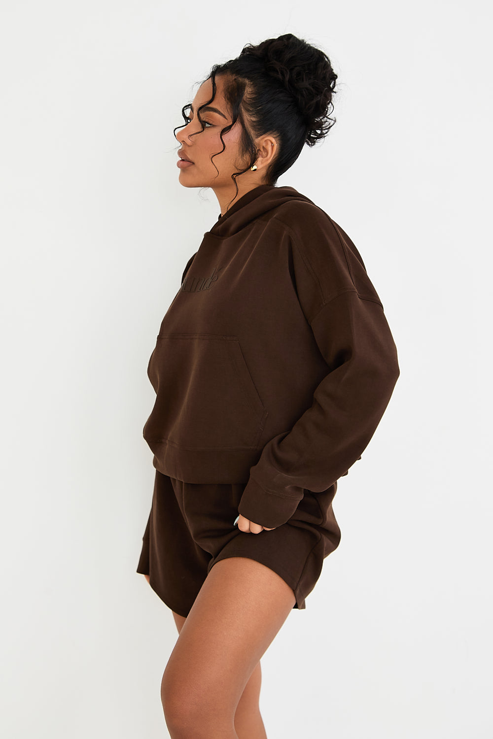 Stay cozy and stylish with our Boxy Cropped Hoodie in rich Chocolate. Made from soft modal, it's perfect for lazy days, paired with matching lounge shorts. Our signature tonal rubber print adds a subtle and sophisticated touch. Upgrade your loungewear collection today.