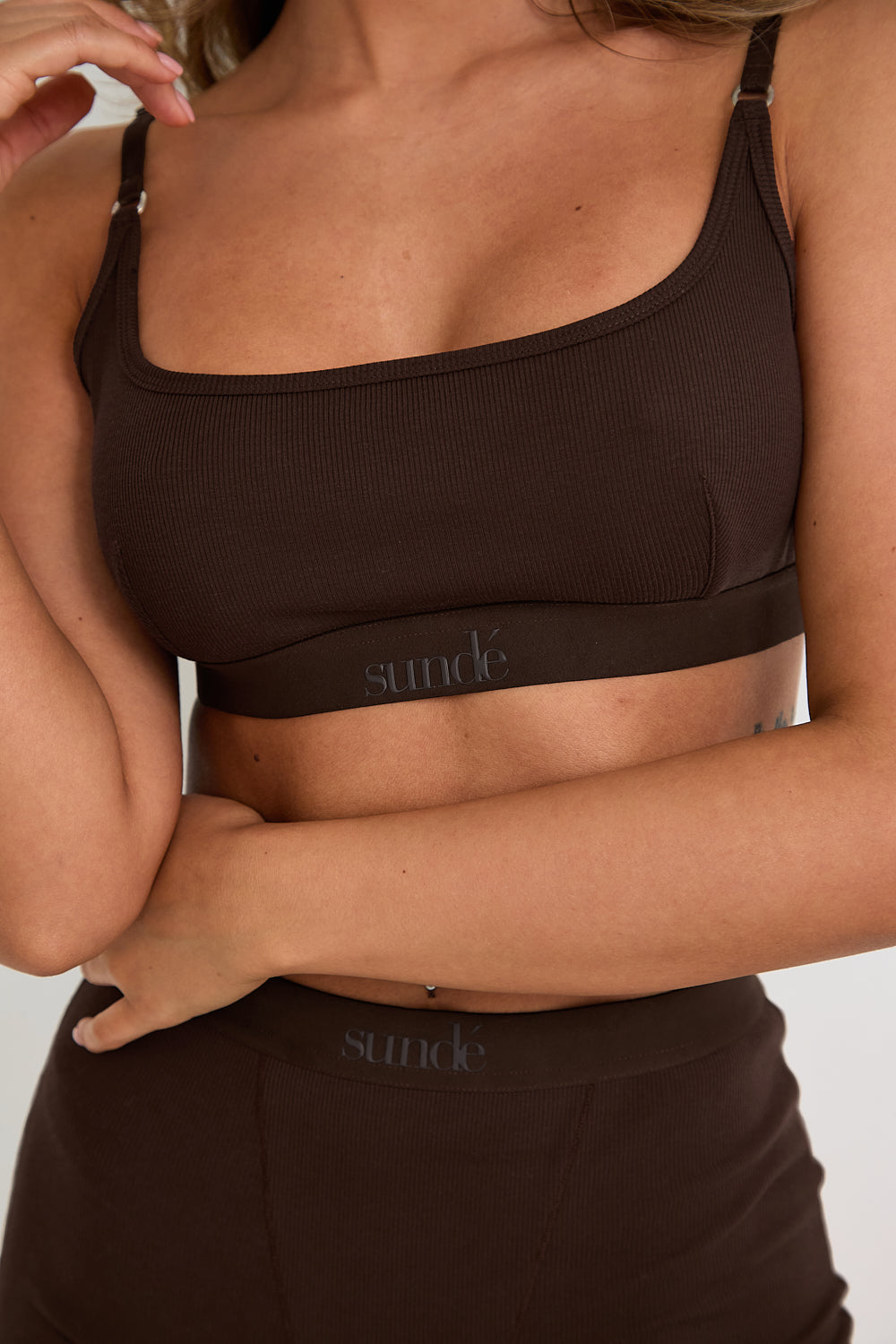 Introducing our Ribbed Strappy Bralet in chocolate - the perfect blend of style and comfort. Made with breathable Lyocel, cotton, and spandex, this seamless bralet offers soft support and a flattering scoop neckline. The 2-way adjustable straps allow for a customised fit, making it ideal for lounging and layering. Elevate your everyday look with its sophisticated ribbed texture.