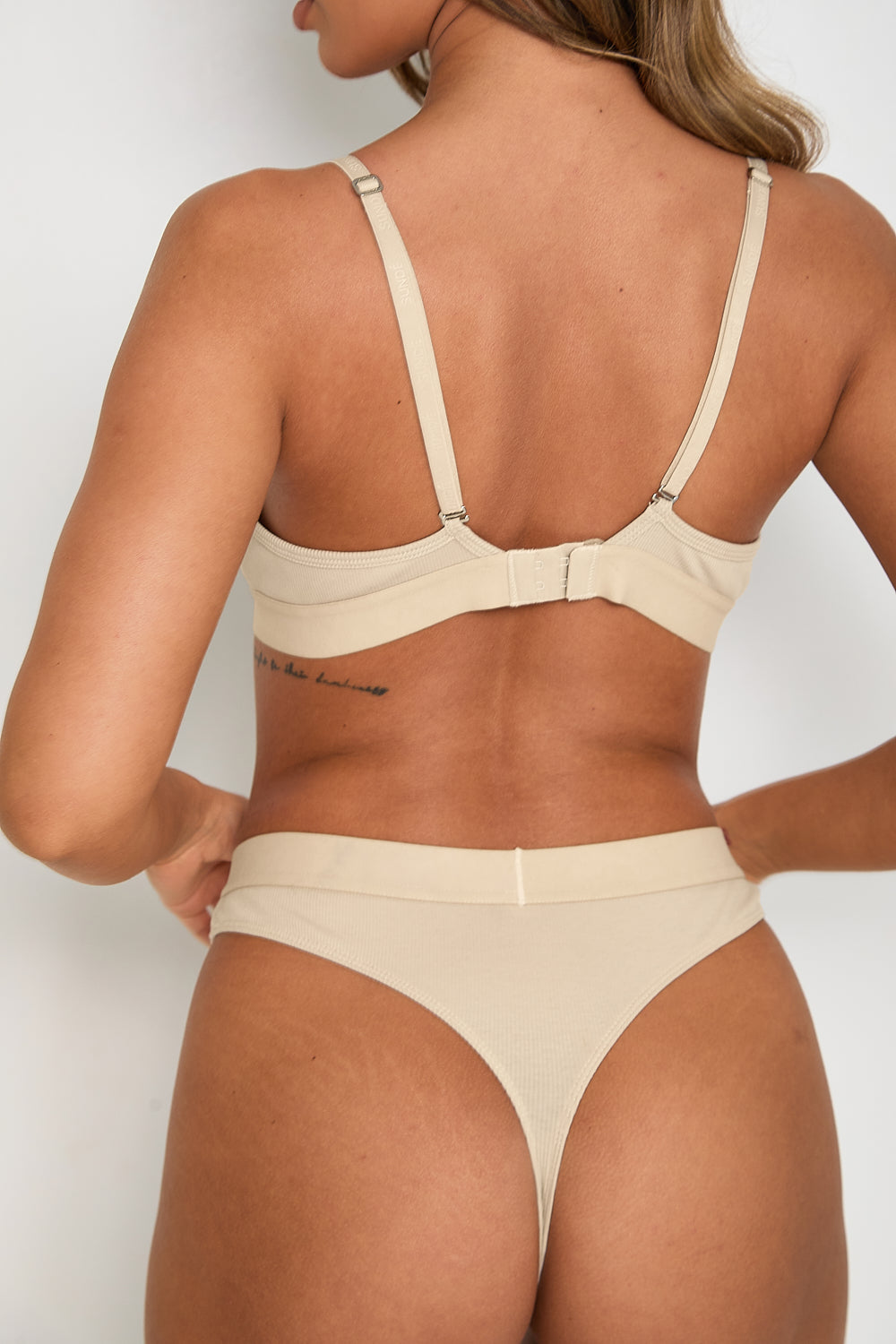 Complete your elegant look with our matching Ribbed Thong in latté. Designed with the same soft and breathable fabric blend as our bralet, this thong offers minimal coverage and a smooth, comfortable fit. The ribbed texture and elastic waistband with our signature logo provide both style and secure support.