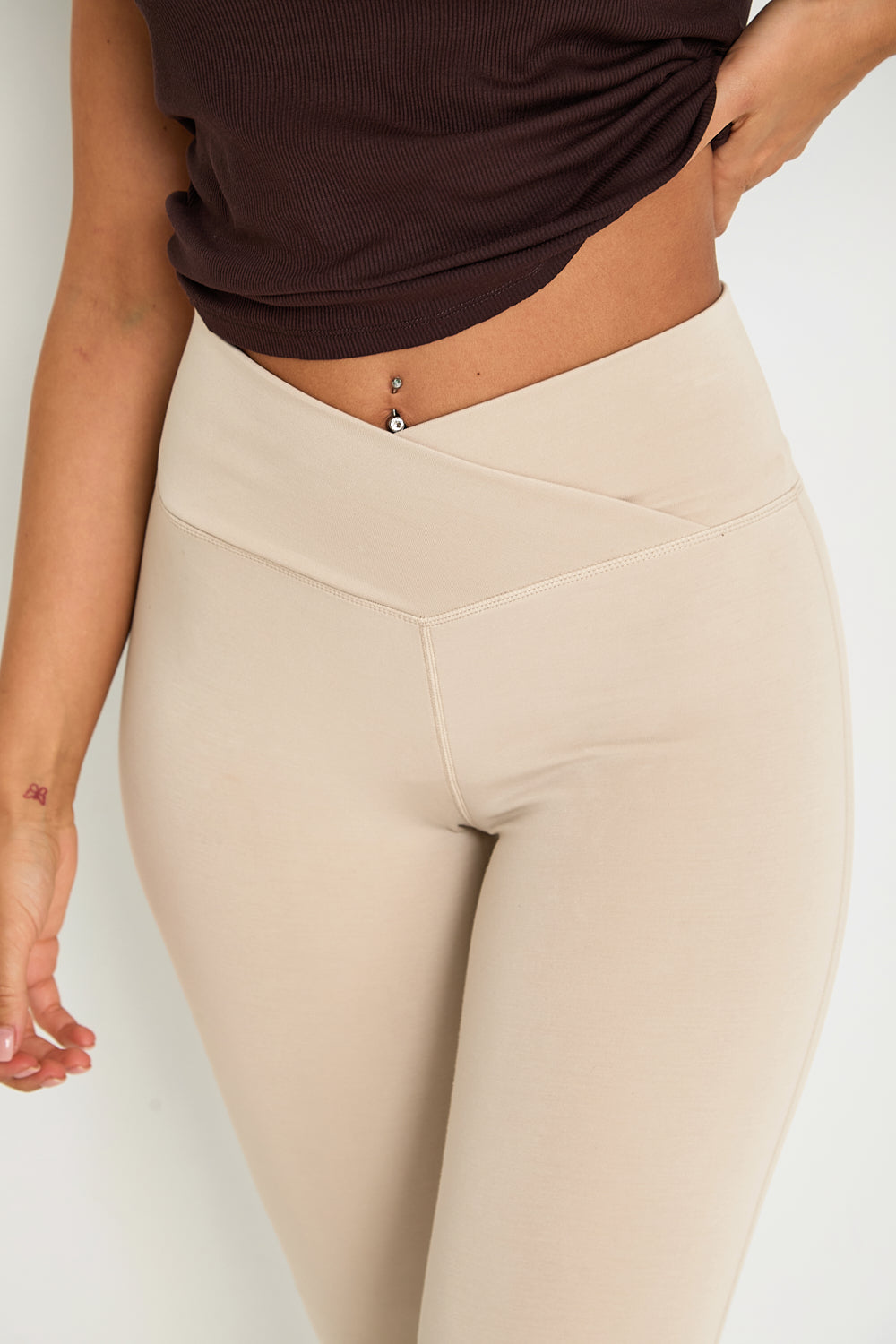 Introducing our Wrap High-Waisted Flare Leggings, crafted from a luxurious modal blend with recycled polyester. Set to be a dreamy bestseller, especially in the "Latte" colour, these leggings feature a flattering wrap high-waist and a velvet-like hand feel for ultimate comfort. Perfect for lounging or casual outings, they combine style and relaxation with our signature tonal branding for an elegant touch.  Pair them with the matching zip-through hoodie for the ultimate in comfort and style.