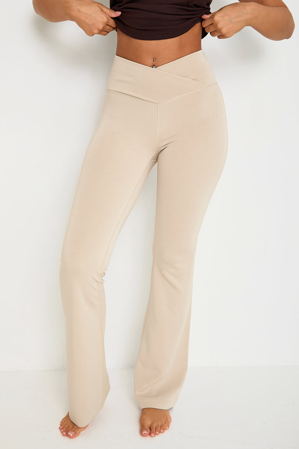 Introducing our Wrap High-Waisted Flare Leggings, crafted from a luxurious modal blend with recycled polyester. Set to be a dreamy bestseller, especially in the "Latte" colour, these leggings feature a flattering wrap high-waist and a velvet-like hand feel for ultimate comfort. Perfect for lounging or casual outings, they combine style and relaxation with our signature tonal branding for an elegant touch.  Pair them with the matching zip-through hoodie for the ultimate in comfort and style.