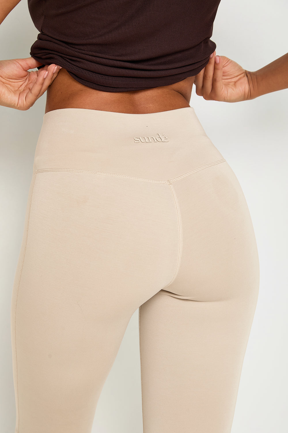 Introducing our Wrap High-Waisted Flare Leggings, crafted from a luxurious modal blend with recycled polyester. Set to be a dreamy bestseller, especially in the "Latte" colour, these leggings feature a flattering wrap high-waist and a velvet-like hand feel for ultimate comfort. Perfect for lounging or casual outings, they combine style and relaxation with our signature tonal branding for an elegant touch.  Pair them with the matching zip-through hoodie for the ultimate in comfort and style.