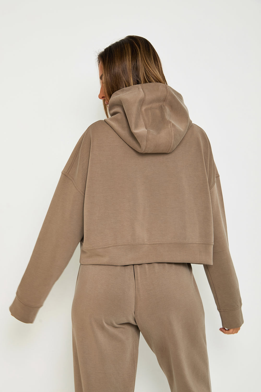 Elevate your loungewear collection with our Boxy Cropped Hoodie in a delicious Mocha colour. Made from soft modal, this hoodie is perfect for both travel and relaxation. The matching lounge flare joggers make for a stylish and comfortable set, while our signature tonal rubber print adds a sophisticated touch. Pair with our basic ribbed tees for a complete look.