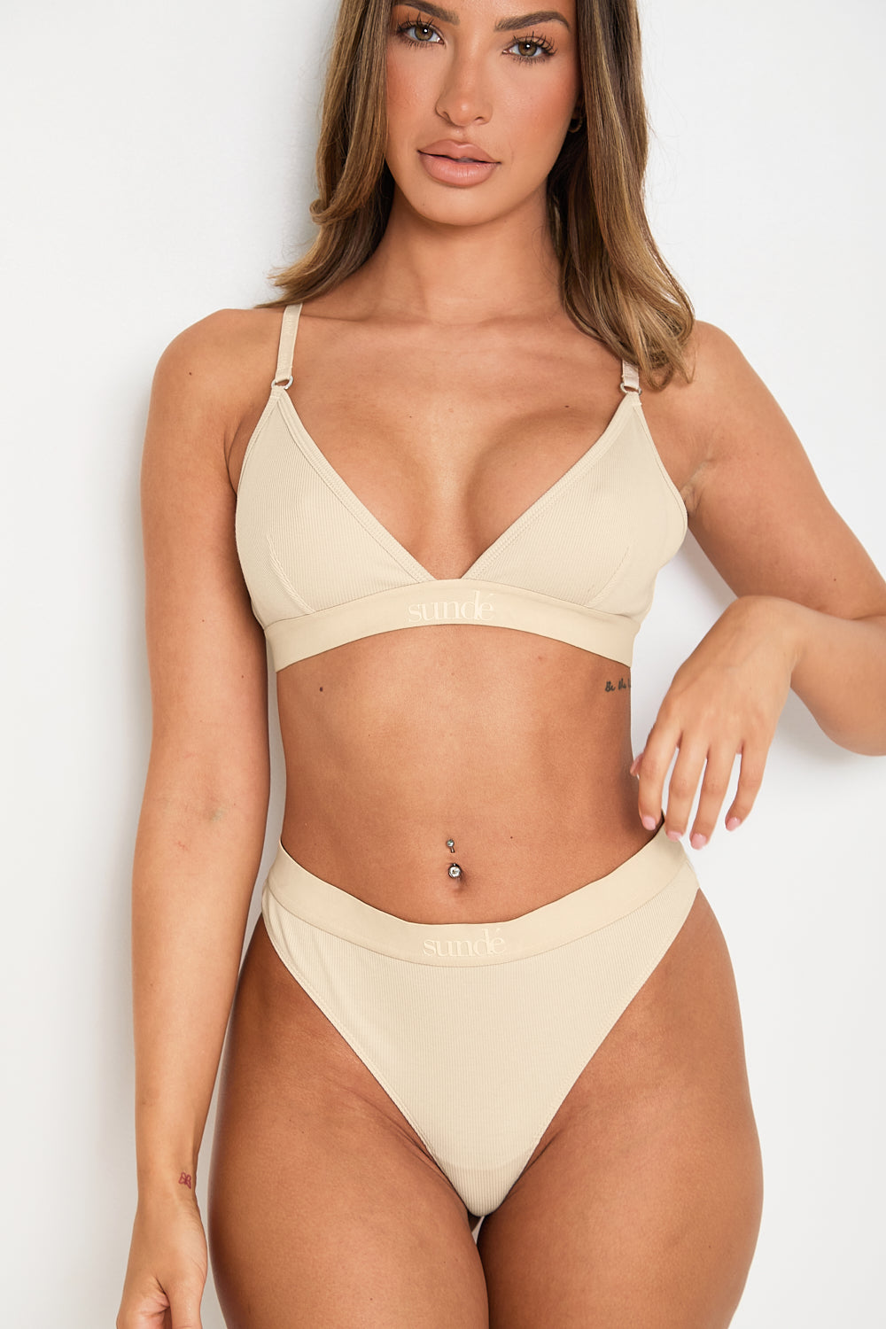  Elevate your style and comfort with our Latte Ribbed Triangle Bralet. Enjoy gentle yet effective support, a triangular neckline, and adjustable 2-way straps for a personalised fit. This seamless bralet boasts a smooth profile under any outfit, thanks to its ribbed design and blend of Lyocell, cotton, and spandex. Perfect for lounging or layering, this essential garment offers both long-lasting comfort and sophisticated appeal, making it a must-have for any fashion-forward wardrobe.