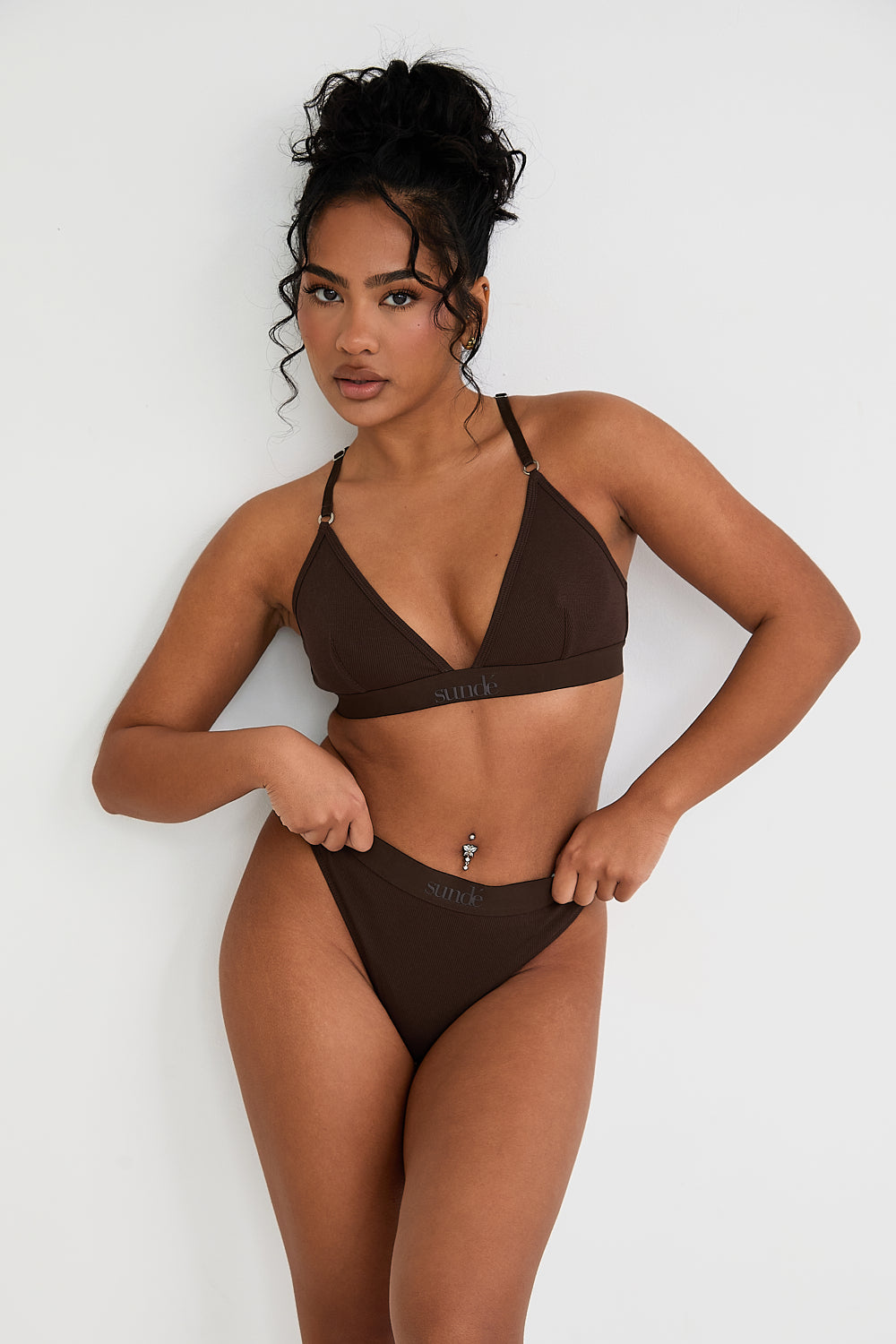 Pair your bralet with our matching Cotton Lyocel Ribbed Thong for a complete look of effortless elegance. The thong offers minimal coverage with maximum comfort, featuring the same soft and breathable fabric blend. The ribbed texture and sleek design ensure a smooth fit under any garment, while the elastic waistband with our signature logo provides a secure yet gentle hold.